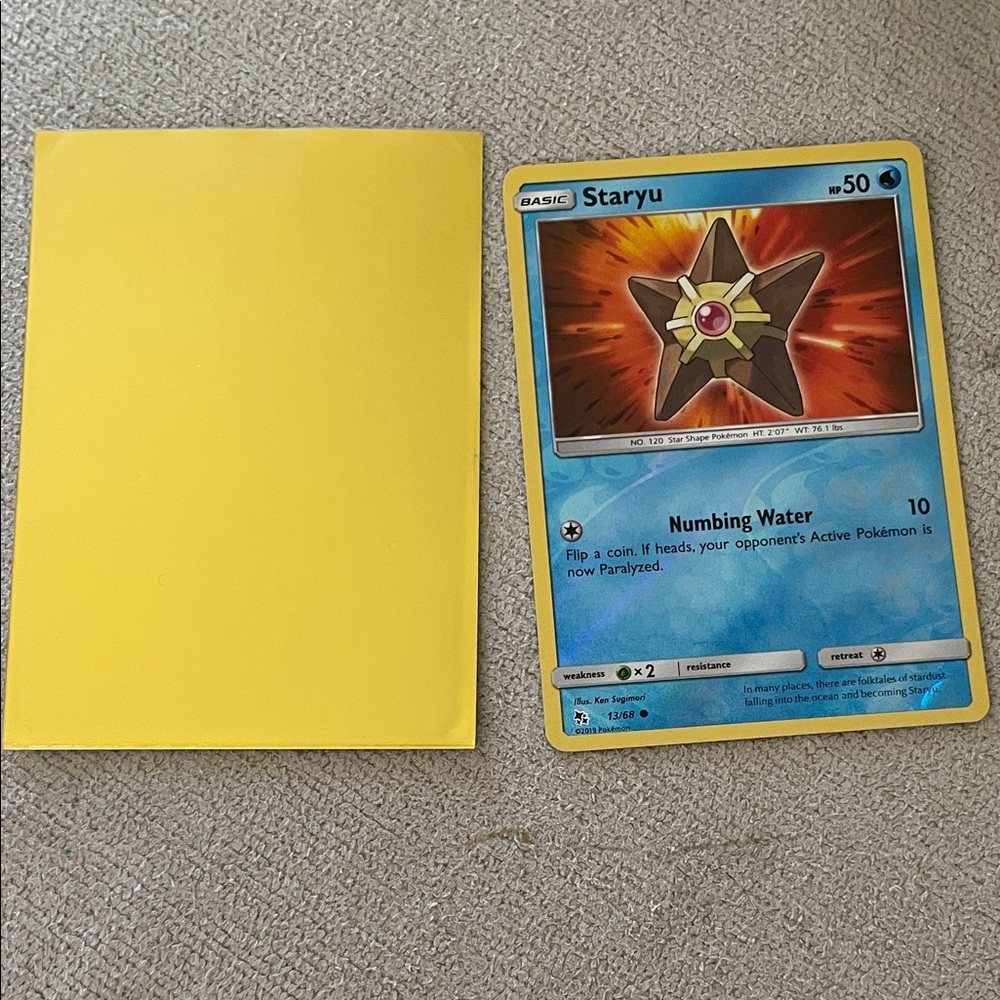 Staryu Pokémon Card holo with Yellow Sleeve